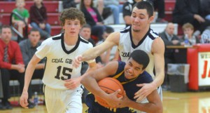 South Point’s John Johnson secures a rebound while Coal Grove’s Alex Bare tries to take the ball away. South Point beat the Hornets 50-36 Tuesday in the Division III sectional tournament semifinals. (Kent Sanborn of Southern Ohio Sports Photos)