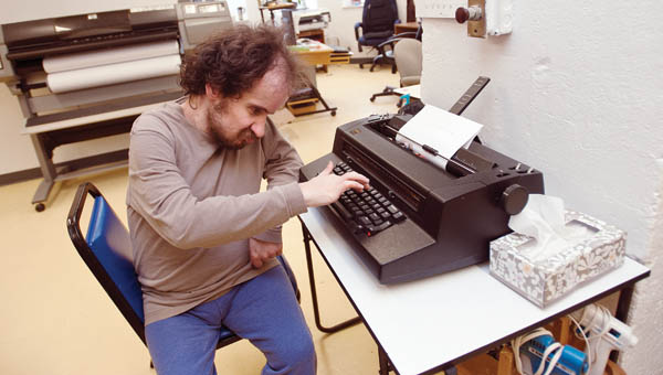 Justin McCreery spends the later part of Tuesday morning typing his name and those of his classmates while attending the adult activity center.