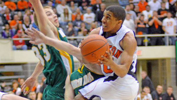 Ironton’s Zac Carter drives to the basket and finishes through contact. The Fighting Tigers hammered the North Adams Green Devils 80-33 in the Division III district semifinals Saturday at Ohio University’s Convocation Center. (Kent Sanborn / Southern Ohio Sports Photos.com)