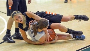 Ironton Lady Tigers’ Alicia Murphy battles Adena’s Alyssa Dawson for a loose ball during Sunday’s Division III district championship game at Ohio University. Ironton shot 19.5 percent in a 41-28 loss to the Lady Warriors. (Kent Sanborn of Southern Ohio Sports Photos.com)