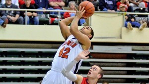 Ironton’s Trevor White (42) scores despite being pushed by Zane Trace’s Tyler Hinty (24) while going up for the shot. Ironton beat Zane Trace 69-45 to win the district title. (Kent Sanborn of Southern Ohio Sports Photos.com)