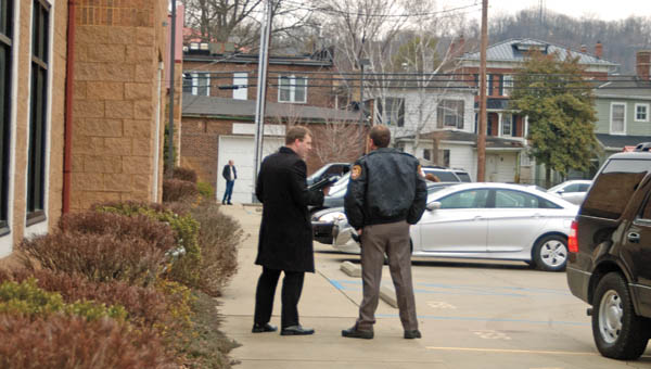 Matt Donahue from the Ohio Attorney General’s Office and Lawrence County Sheriff Jeff Lawless confer in the parking lot of the Pinnacle Wellness and Longevity Center, 407 S. Third St., Suite B, Ironton. The wellness center, suspected of being an alleged pill mill, has been the focus of an investigation by the office of Ohio Attorney General Mike DeWine for the past year.