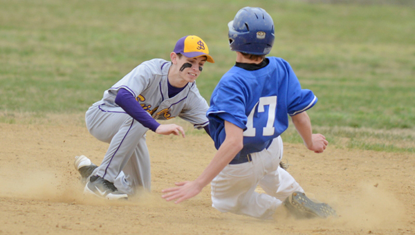 St. Joseph Flyers’ Joseph Payton (left) tags out a Sciotoville East runner sliding into second base. The Flyers beat the Tartans 16-5 on Thursday. (Tony Shotsky of Southern Ohio Sports Photos.com)