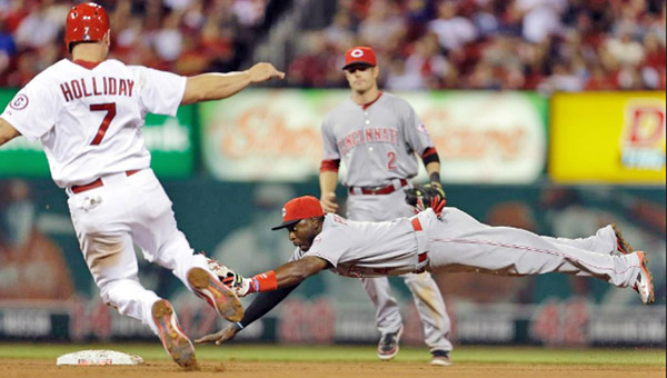 Cincinnati Reds’ second baseman Brandon Phillips dives to beat St. Louis’ Matt Holliday to the base on a force out for the final out of the fifth inning. The Reds beat the Cardinals 2-1 on Monday. (Photo Courtesy of the Cincinnati Reds.com)