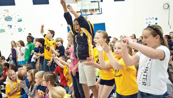 Students from Team Roberts jump up and down and scream as they are recognized during an academic pep rally at South Point Elementary School.