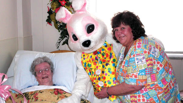 The Easter Bunny visits with Sanctuary of the Ohio Valley resident, Johanna Meeks, right, and facility beautician, Joanie Nelson during a visit to the Sanctuary for its first ever Easter egg hunt event.