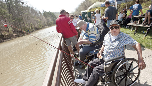 Frank Cooper chills out on the Lake Vesuvius boardwalk while enjoying lunch and fishing the day away during the Wheelin’ Sportsmen Fishing Day. This marks the 10th year anniversary of the event that is sponsored by the Wayne National Forest and National Wild Turkey Federation.