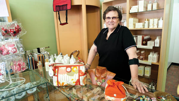 Rowena Mollett shows off some of the gift items at her new shop, Downtown Emporium, located in downtown Ironton.