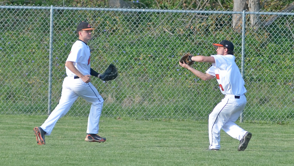 Ironton outfielder Korey Kellogg (right) chases down a fly ball for an out. The Fighting Tigers beat the Coal Grove Hornets 9-4 on Wednesday in the Division III sectional tournament. (Kent Sanborn of Southern Ohio Sports Photos)