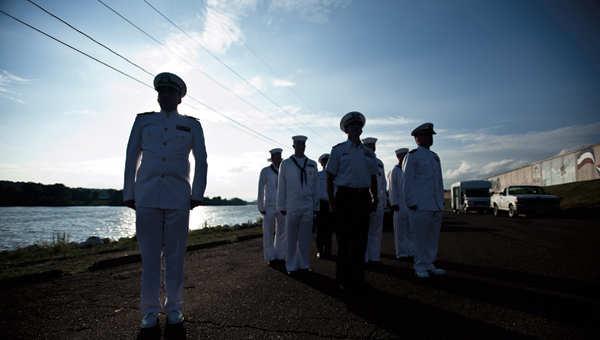 Members of the Navy Operational Support Center Eleanor in West Virginia stand at attention during the post of colors at the annual Navy Night Memorial Service event Thursday at the Center Street Boat Landing in Ironton.