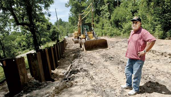 Area resident Dale Blakeman stands on a section of County Road 6 that is now blocked due to construction delays.