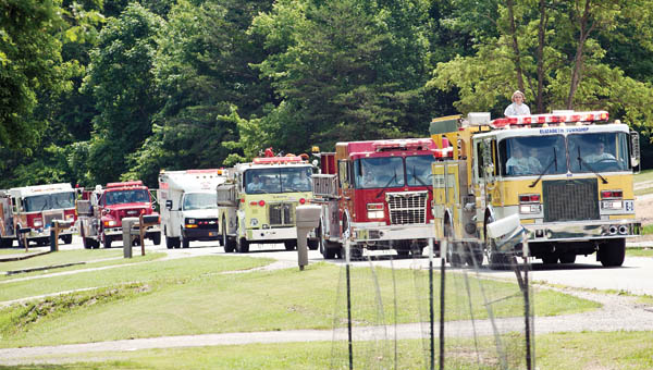 A fire truck parade from Elizabeth, Rome, South Point and Upper townships makes its way down County Road 26.