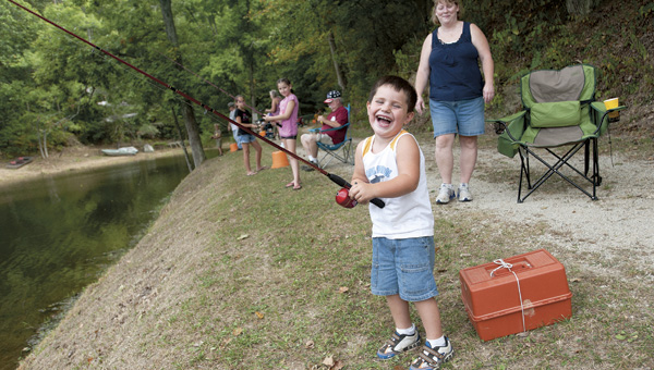 Noah Clifton breaks out into laughter, while mother Ruthie watches, at last fall’s Izaak Walton Fishing Derby in Aid Township.