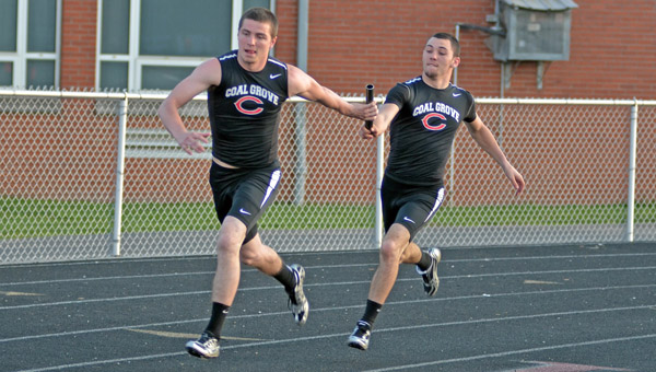 Coal Grove Hornets’ senior Bryan Steele (left) takes the baton from Alex Bare during the 4x100 relay event. Steele has returned from ACL surgery in August to enjoy a stellar track season. (Kent Sanborn of Southern Ohio Sports Photos)