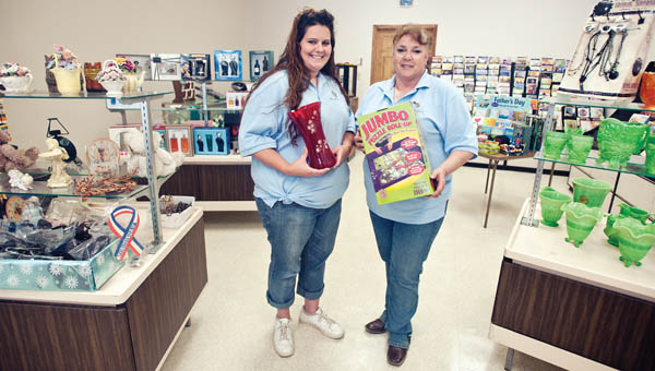 Dee Staley Best, right, pictured with her employee Kendra Friend has opened a new Ironton business Pack Horse, LLC that allows customers to pay their bills or shop for Fenton glass, games, perfume and much more.
