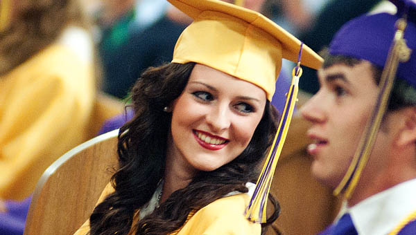 Shelby Lin Campbell peers over her shoulder at the start of commencement at St. Joseph High School Friday.