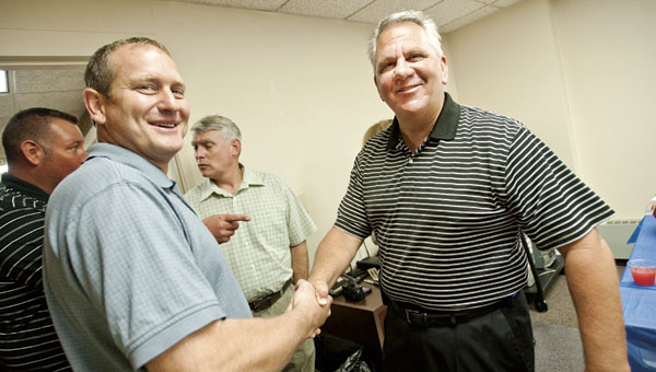 Sheriff Jeff Lawless, left, shakes the hands of recently retired Lawrence Drug and Major Crimes Task Force director Tim Sexton at his retirement party Wednesday at the Lawrence County Courthouse.
