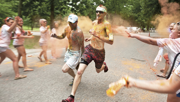Powdered paint floats in the air as participants in the Color Splash 5K cross the finish line Saturday morning in Central Park in Ashland, Ky.