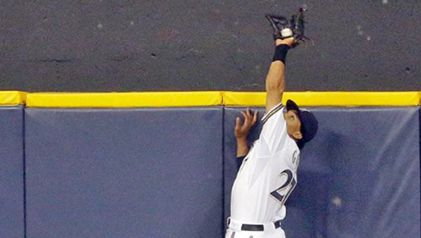Milwaukee Brewers’ centerfielder Carlos Gomez makes a leaping catch to rob Joey Votto of a two-run homer in the ninth inning and preserve a 4-3 win on Monday. (Photo Courtesy of The Cincinnati Reds)