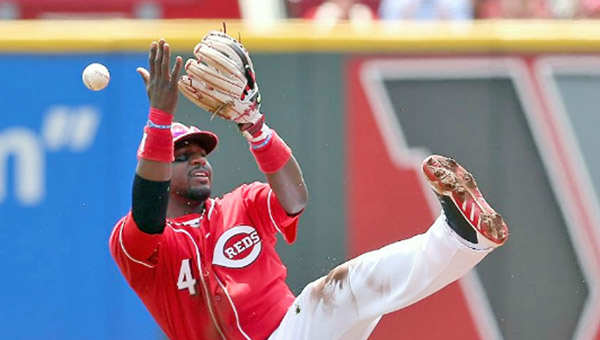 Cincinnati second baseman Brandon Phillips has trouble fielding a ground ball by Seattle’s Kyle Seager during Sunday’s game. The Reds lost to Seattle 3-1. (Photo Courtesy of The Cincinnati Reds)