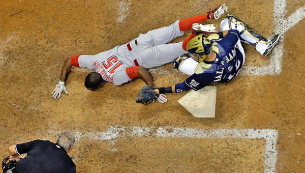 Cincinnati’s Derrick Robinson (15) is tagged out at home plate by Milwaukee Brewers’ catcher Martin Maldonado as he tries to complete a potential inside-the-park home run. The Reds lost 2-0. (Photo Courtesy of The Cincinnati Reds)