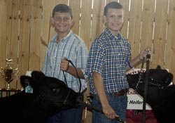 Uriah Cade, at left, won grand champion in the feeder heifer category while his cousin, Ethan Cade, won reserve champion.