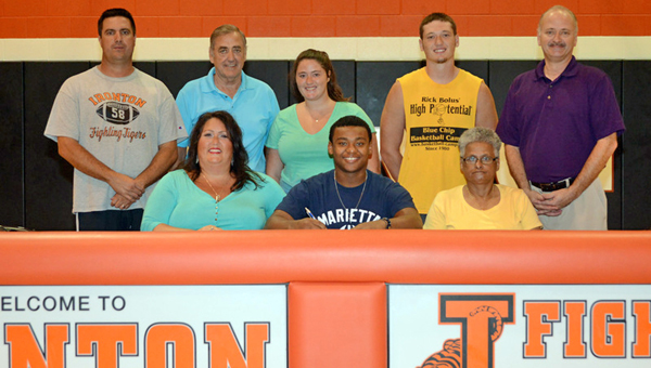 Ironton Fighting Tigers’ senior running back Patrick Lewis signed a letter-of-intent to play for Marietta College. Attending the signing ceremony were: seated from left to right, Heather Dutey, Patrick, grandmother Jackie Birchfield; standing from left to right, Ironton head coach Mark Vass, Gary Dutey, Taitlyn Dutey, Tanner Dutey and Scott Dutey. (Tony Shotsky of Southern Ohio Sports Photos)