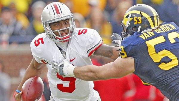 Ohio State Buckeyes’ quarterback Braxton Miller tries to escape the grasp of a Michigan defender during a game last season. Miller said he is doing a better job of handling the spotlight this year. (MCT Direct Photos)