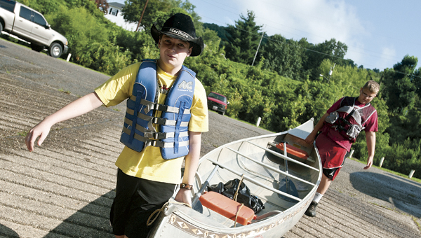 Ethan Booth, left, and Thomas Johnson, right, both with South Point Boy Scout Troop 115 prepare to launch their canoe for the annual Symmes Creek Canoe Caper Saturday.