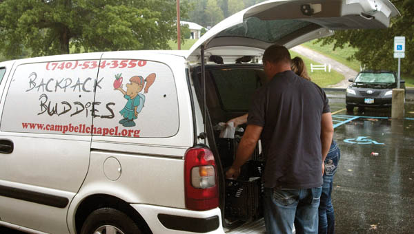 Jodie and Jason Hunt unload the Backpack Buddies van at the Rock Hill School District Thursday. Each week, food is brought in for children in need to take home over the weekend.