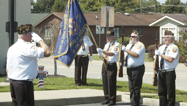 Members of Veterans of Foreign Wars Post 6878, Proctorville, stand attention as Taps is played during the 9/11 ceremony at WesBanco in Proctorville on Saturday.