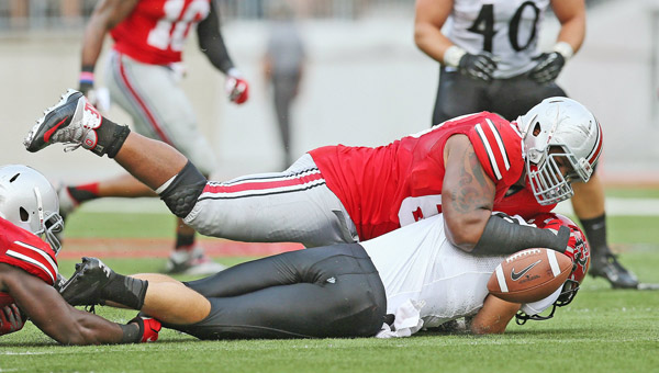 Ohio State Buckeyes defensive lineman Michael Bennett (63) forces a fumble as he sacks San Diego State Aztecs quarterback Quinn Kaehler (18) during a game earlier this season. Bennett is one of the key players on the Buckeyes’ defense. (MCT Direct Photo)