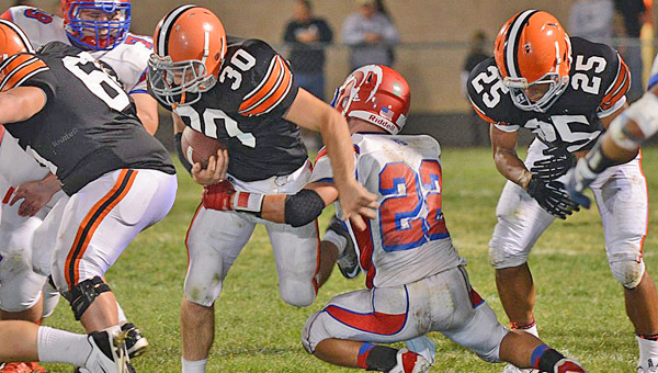 Ironton Fighting Tigers’ fullback Trevor Easterling (30) gets a block from Brock Midkiff-Sands (66) as he tries to run through the tackle of Portsmouth’s Johnnie Charles during Friday’s game. Ironton lost to the Trojans 33-20 in the annual homecoming game. (Tony Shotsky of Southern Ohio Sports Photos)