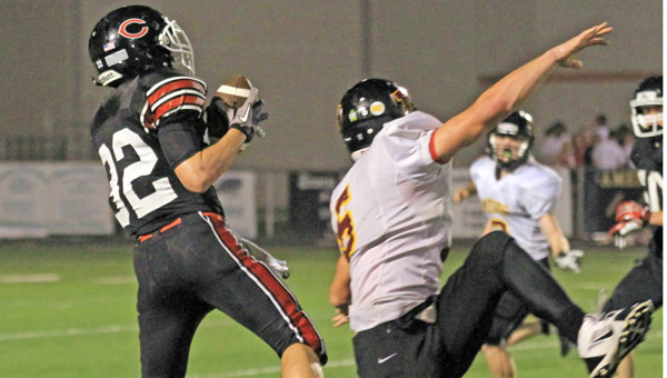 Coal Grove Hornets’ end Conor Markins (32) makes a catch behind the Meigs’ secondary during last week’s game. The Hornets travel to Wheelersburg on Friday for a key non-conference game. (Joe Stevens of FJS Photos.com)