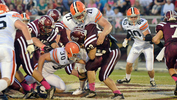 Ironton defensive tackle Adam Webb (71) wraps up Ashland fullback Josh Vaughn while Trevor Easterling (30) helps Webb on the stop. Ironton had four turnovers in a 42-20 loss at Ashland on Friday. (Tony Shotsky of Southern Ohio Sports Photos)