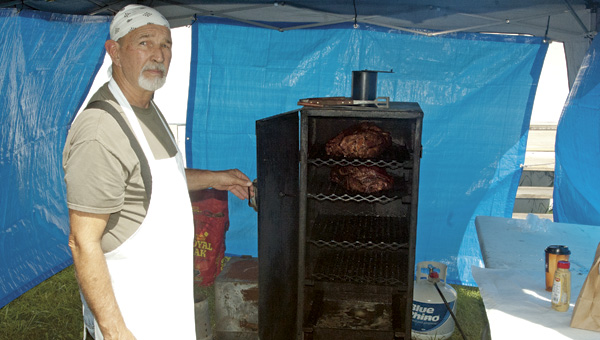 Robin Russell shows two 10-pound chunks of pork being smoked on a custom-made stoker he made in his garage. Stoker Bar-B-Que, inside Tipton’s Mini Mart on State Route 93, has pulled pork and barbeque pulled pork sandwiches and sides prepared on site.