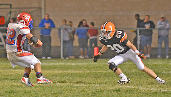 Ironton Fighting Tigers’ senior defensive back Blake Taylor (20) closes in to make the stop on Portsmouth running back Johnnie Charles during last week’s game. Ironton hosts Johnson Central Friday. (Tony Shotsky of Southern Ohio Sports Photos)
