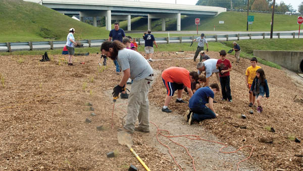 Volunteers work to plant a garden of native plants at St. Mary’s Medical Center-Ironton Campus in Ironton.