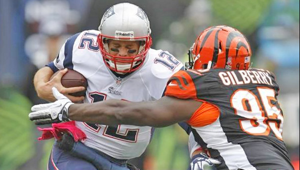 Cincinnati Bengals' defensive lineman Wallace Gilberry (95) brings down New England Patriots' quarterback Tom Brady. The Bengals handed the Patriots their first loss of the season on Sunday. (Photo Courtesy of the Cincinnati Bengals.com)