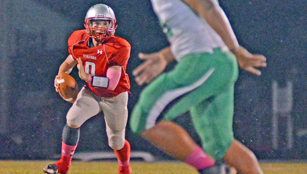 Symmes Valley Vikings’ quarterback Payton Hayes (8) looks at an opposing team defender and plans his next move as he gains yardage in a recent game. The Vikings host Portsmouth Notre Dame Friday. (Courtesy Robert S. Stevens and The Gold Studio of Ironton)