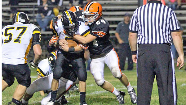 Ironton Fighting Tigers’ junior linebacker Harley Paholsky (64) makes the stop on Johnson Central running back Josh Gound during Friday’s game at Tanks Memorial Stadium. Ironton fell to the unbeaten Eagles, 56-14. (Courtesy Tim Gearhart of Tim’s News & Novelties in Ironton)