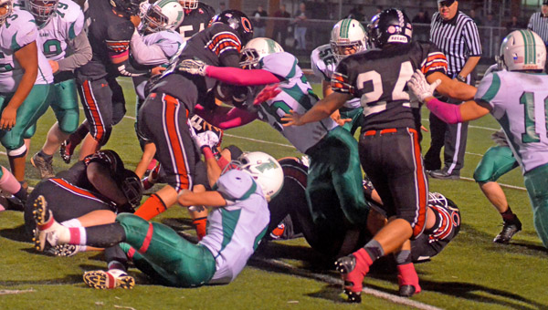 Fairland Dragons’ defensive player Derick Willis (26) stops Coal Grove Hornets’ running back Isaiah Gunther (8) on a running play during Friday’s Ohio Valley Conference game. The Dragons won 44-27 to take over sole possession of first place. (Kent Sanborn of Southern Ohio Sports Photos)