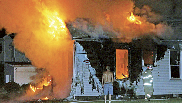 Firefighters respond to a blaze in the 500 block of Heplar Street in Ironton early this morning. The fire was fully involved and a woman was taken by EMS to a local hospital to be treated for minor burns and smoke inhalation.