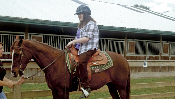 Ohio University Southern equine studies student Jamie Nelson, of Salt Rock, W.Va., rides Ivy at the Ohio Horse Park. Nelson is also a volunteer in the park’s therapeutic horsemanship program.