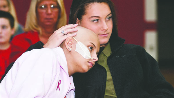 Laken Short offers a shoulder to lean on to her friend Ashley Dennison during the National Honor Society Fashion Show benefit event at Rock Hill Saturday. The event was held on honor of Ashley whom is battling cancer.