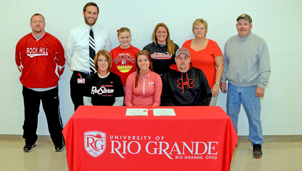 Rock Hill Redwomen senior softball standout Brooke Hanshaw signed a letter-of-intent to play for the University of Rio Grande. Attending the signing ceremony were: seated from left to right, mother Amy Hanshaw, Brooke, and father Ryan Hanshaw; standing from left to right, Rock Hill assistant coach Greg Damron, Rock Hill head coach Sammy Gue, sister Makenzie Hanshaw, Rio Grande head coach Kristen Bradshaw, former Rock Hill head coach Mary Harper and former Rock Hill assistant coach Mark Harper. (Kent Sanborn of Southern Ohio Sports Photos)