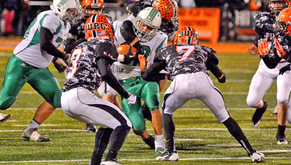 Fairland Dragons’ running back Evan Maddox (32) runs inside against the Wheelersburg defense. The Pirates’ Austin May (7) and Tyler Claxon (3) attempt to make the stop. Fairland lost the playoff game 40-21. (Kent Sanborn of Southern Ohio Sports Photos)