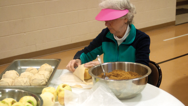 Members of the First Baptist Church of Ironton peel apples. Every year the church makes and sales apple dumplings as part of a fundraiser.