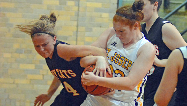 St. Joseph Female Flyers center Bri Bridges (right) fights to take a rebound from Whiteoak’s Emily Stratton (4) during a 57-44 win Thursday. (Kent Sanborn of Southern Ohio Sports Photos)