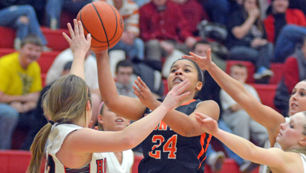 Ironton Lady Fighting Tigers’ Alyssa Lewis (24) gets off a shot whiile surrounded by Coal Grove defenders during Monday’s game. Ironton won 58-43. (Kent Sanborn of Southern Ohio Sports Photos)